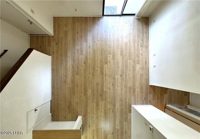 bonus room featuring light carpet, lofted ceiling, and a textured ceiling