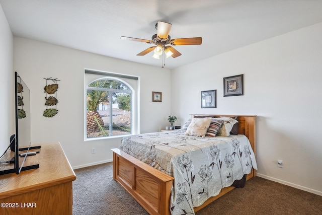 bedroom featuring baseboards, dark colored carpet, and a ceiling fan