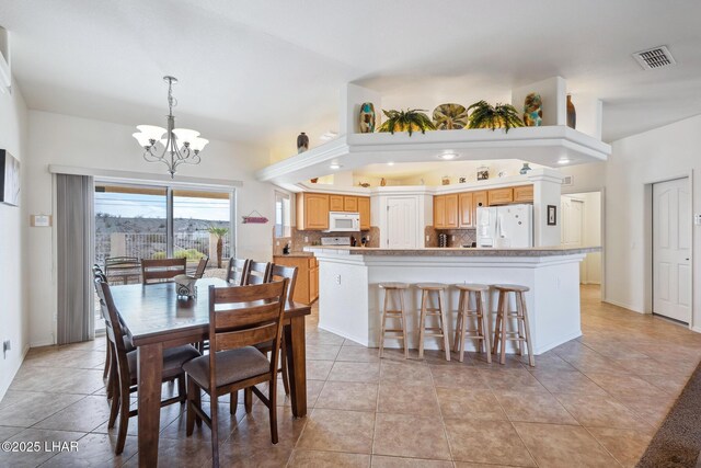 dining area with visible vents, a notable chandelier, baseboards, and light tile patterned floors