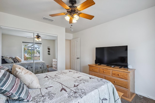 bedroom with carpet, a closet, visible vents, a ceiling fan, and baseboards