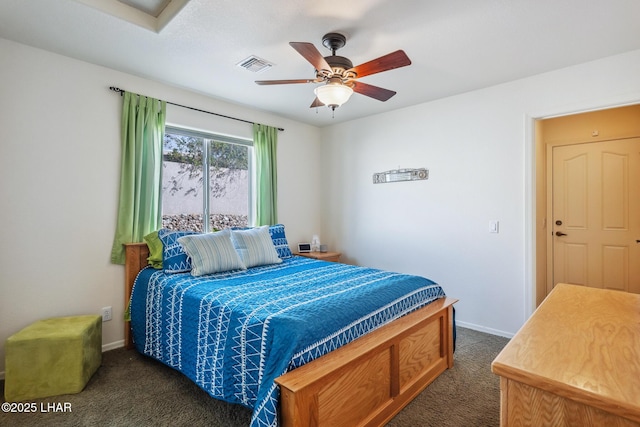 bedroom featuring baseboards, visible vents, dark colored carpet, and a ceiling fan