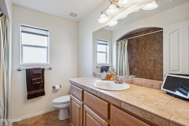 bathroom featuring toilet, tile patterned floors, vanity, visible vents, and a shower with curtain