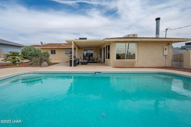 outdoor pool with fence, an outdoor living space, and a patio area