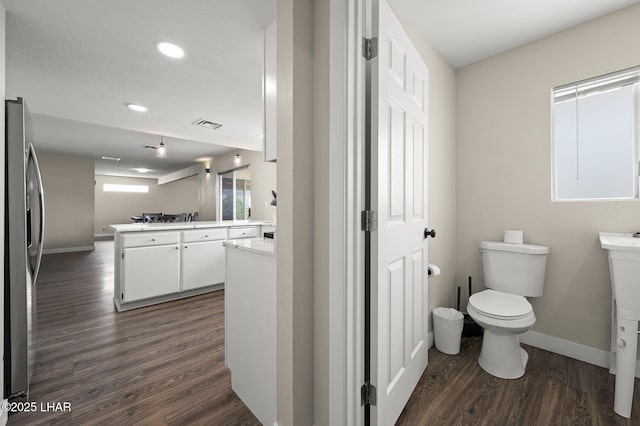 bathroom featuring vanity, toilet, and wood finished floors
