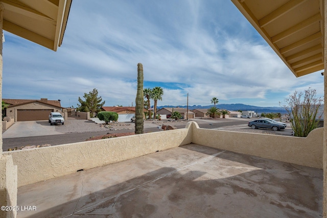 view of patio featuring a residential view and a mountain view