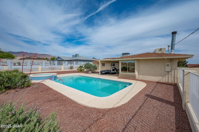 view of pool with a fenced backyard, a patio area, a pool with connected hot tub, and an outdoor hangout area