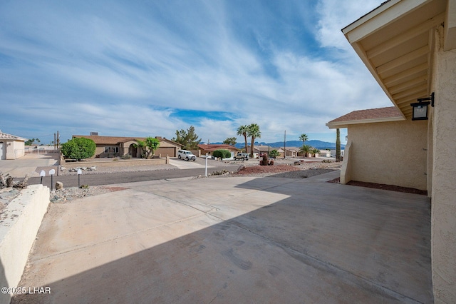 view of patio with a residential view and a mountain view