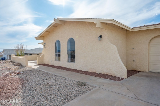 view of home's exterior with a garage and stucco siding