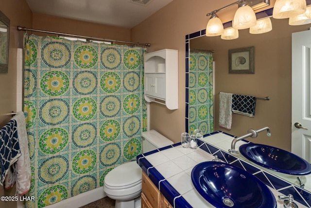 bathroom with visible vents, toilet, vanity, and a shower with curtain