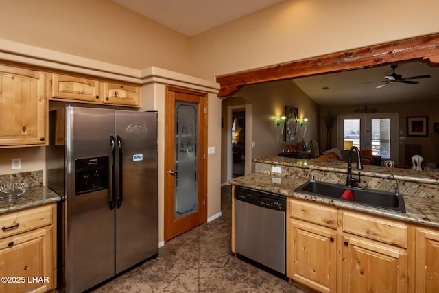 kitchen featuring ceiling fan, appliances with stainless steel finishes, a sink, and light brown cabinetry