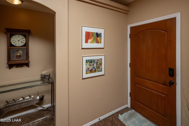 doorway to outside with baseboards