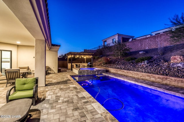 view of pool featuring a patio area, a fenced backyard, and a pool with connected hot tub