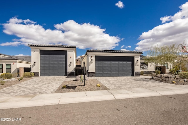 view of front of property with stone siding, a tile roof, and stucco siding