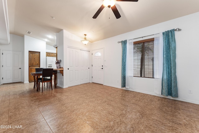 entrance foyer featuring vaulted ceiling, tile patterned floors, and ceiling fan