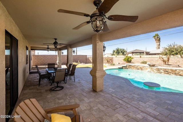 view of patio with a fenced in pool and ceiling fan