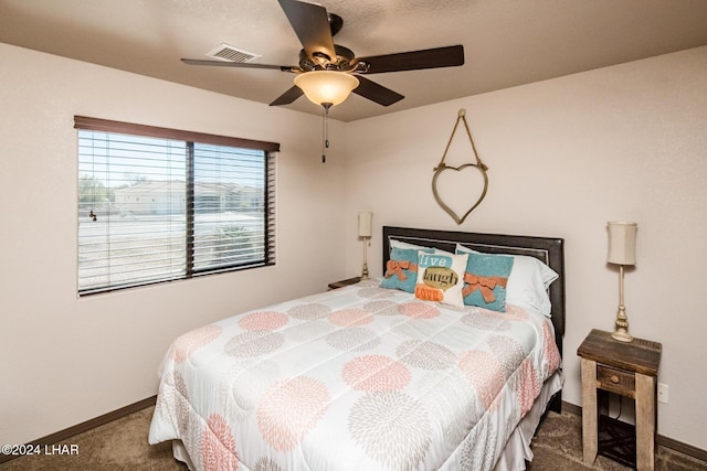 bedroom featuring ceiling fan and carpet