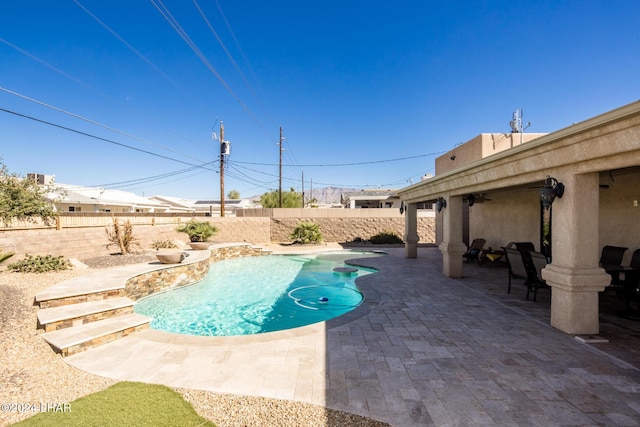 view of swimming pool with ceiling fan and a patio area