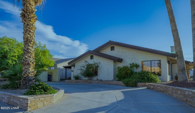 view of front facade featuring concrete driveway and stucco siding