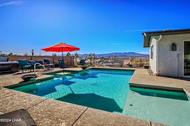 view of pool featuring a mountain view and a patio area