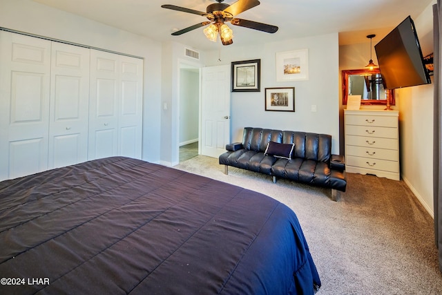 carpeted bedroom featuring a closet and ceiling fan