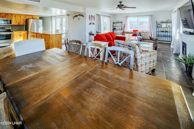 dining room featuring tile patterned flooring and ceiling fan