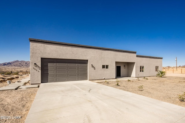 view of front of property featuring a mountain view and a garage