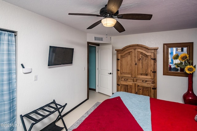 bedroom featuring a textured ceiling and ceiling fan