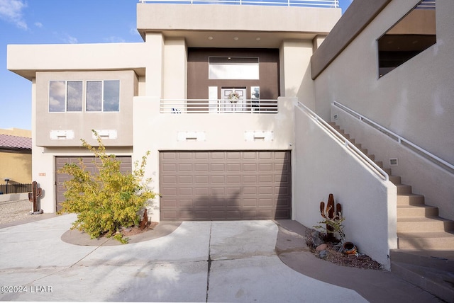 view of front of home featuring a garage and a balcony