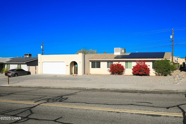 view of front of home featuring a garage and a carport