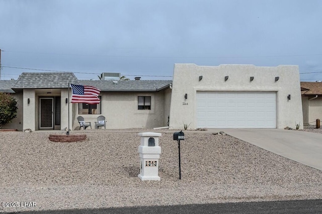 1364 Candy Dr, Lake Havasu City, AZ 86404 - adobe home featuring a garage, driveway, stucco siding, and a shingled roof