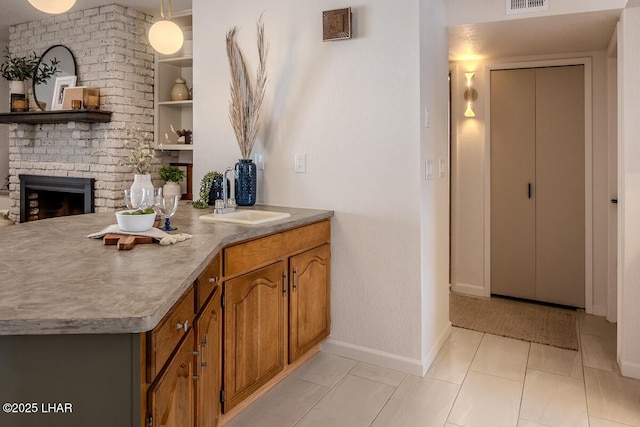 1364 Candy Dr, Lake Havasu City, AZ 86404 - bar featuring a sink, a fireplace, light tile patterned floors, baseboards, and visible vents