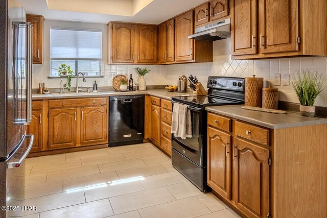 1364 Candy Dr, Lake Havasu City, AZ 86404 - kitchen with under cabinet range hood, decorative backsplash, a sink, black appliances, and brown cabinetry