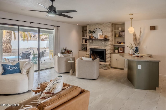 1364 Candy Dr, Lake Havasu City, AZ 86404 - living area with built in features, light tile patterned flooring, a ceiling fan, and a brick fireplace