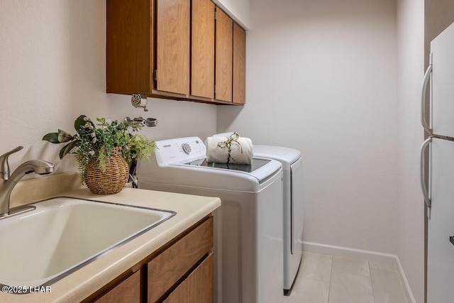 1364 Candy Dr, Lake Havasu City, AZ 86404 - laundry area featuring washing machine and clothes dryer, a sink, cabinet space, and baseboards