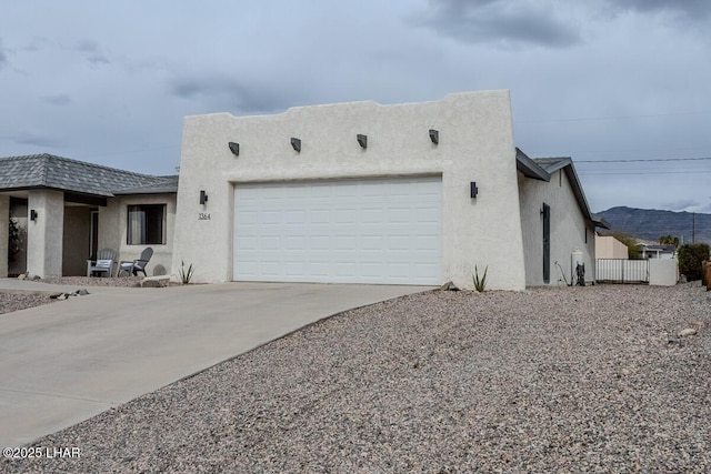 1364 Candy Dr, Lake Havasu City, AZ 86404 - view of front of house featuring concrete driveway, stucco siding, fence, and an attached garage