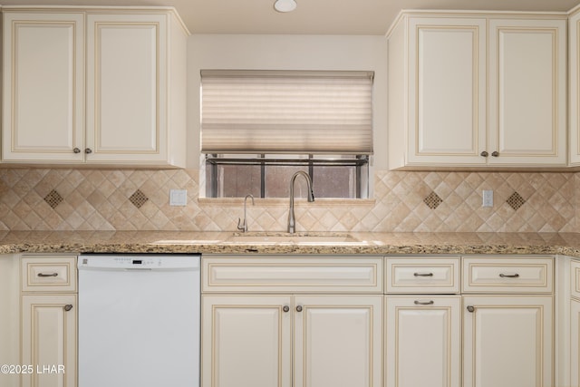 kitchen with dishwasher, light stone countertops, sink, and decorative backsplash