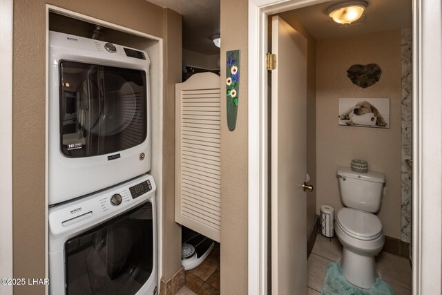 1650 Smoketree Ave S Unit 175, Lake Havasu City, AZ 86403 - laundry area featuring stacked washing maching and dryer, laundry area, baseboards, and tile patterned floors