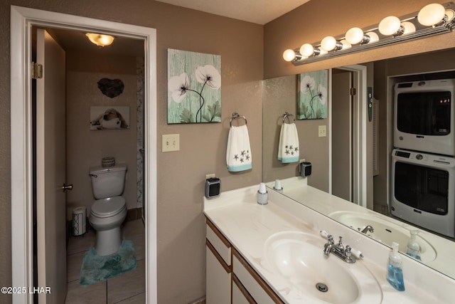 1650 Smoketree Ave S Unit 175, Lake Havasu City, AZ 86403 - bathroom featuring tile patterned floors, vanity, stacked washer / drying machine, and toilet