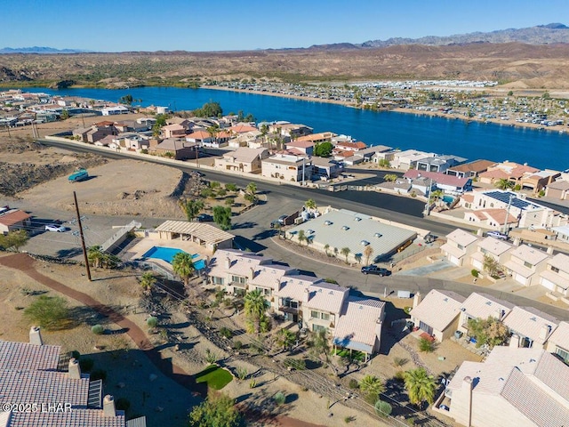 birds eye view of property with a water view and a residential view