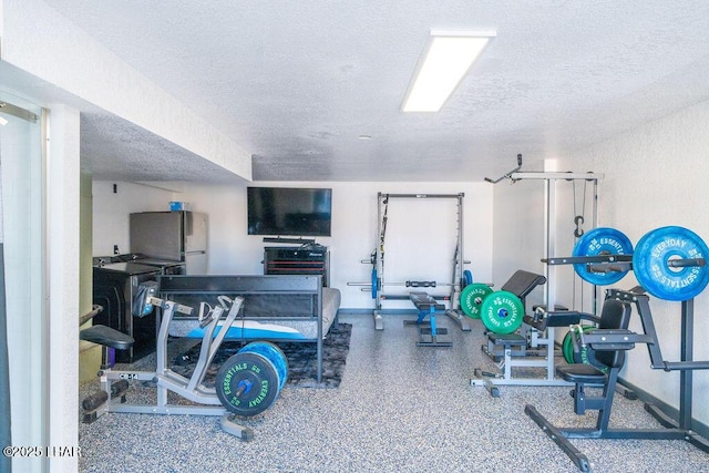 exercise room featuring a textured ceiling