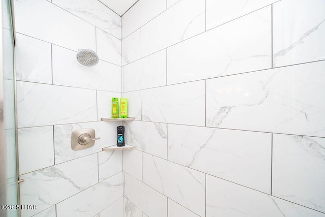 interior details featuring tiled shower