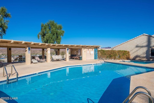 community pool featuring a patio, a community hot tub, and fence