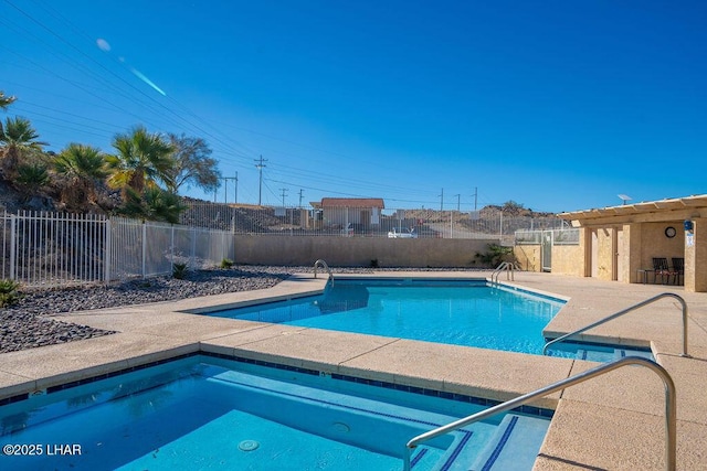 community pool with a patio, a community hot tub, and fence