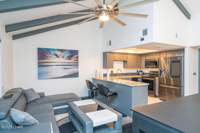 living area featuring high vaulted ceiling, beam ceiling, visible vents, and a ceiling fan