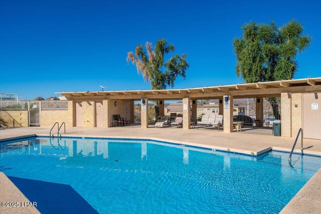 community pool featuring a patio area and fence