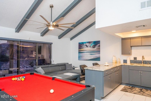 recreation room featuring vaulted ceiling with beams, marble finish floor, a sink, and visible vents