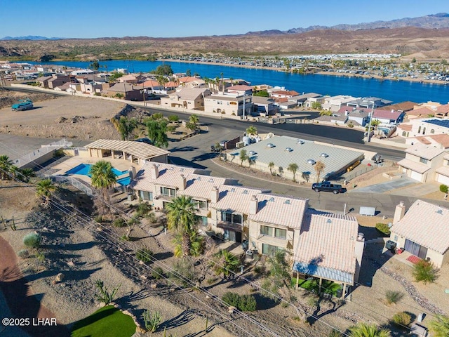 birds eye view of property with a water and mountain view and a residential view