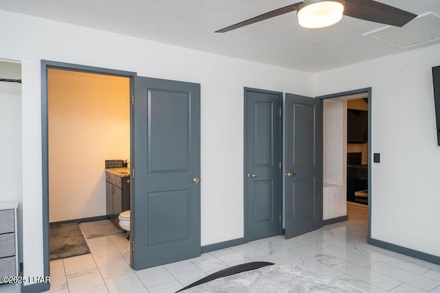 bedroom with marble finish floor, connected bathroom, and baseboards