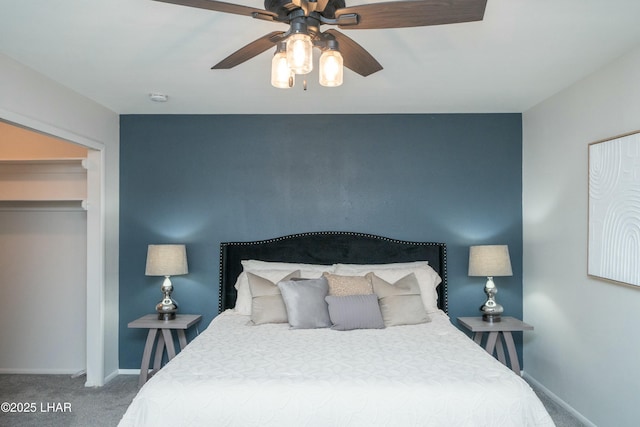 carpeted bedroom with baseboards and a ceiling fan