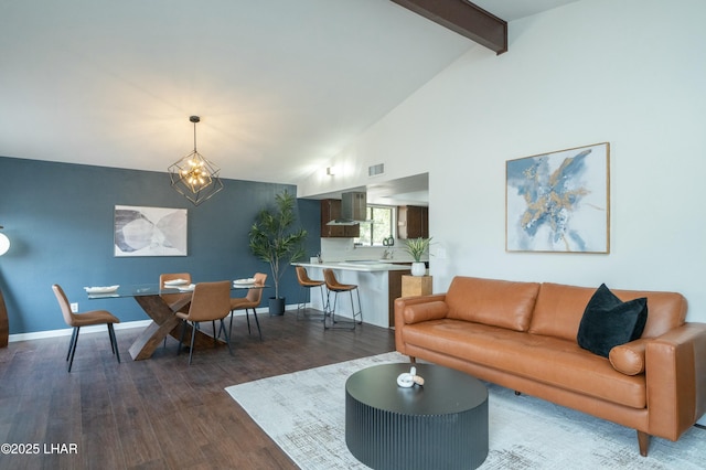 living area with dark wood-style floors, a notable chandelier, visible vents, beamed ceiling, and baseboards